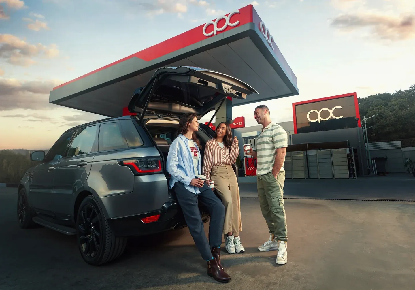 CPC campaign with three people beside a car at a petrol station in daylight