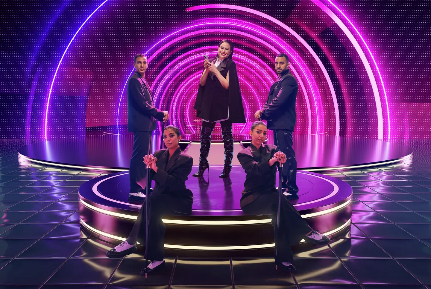 WE campaign scene with a woman singing among dancers and concentric purple neon arches