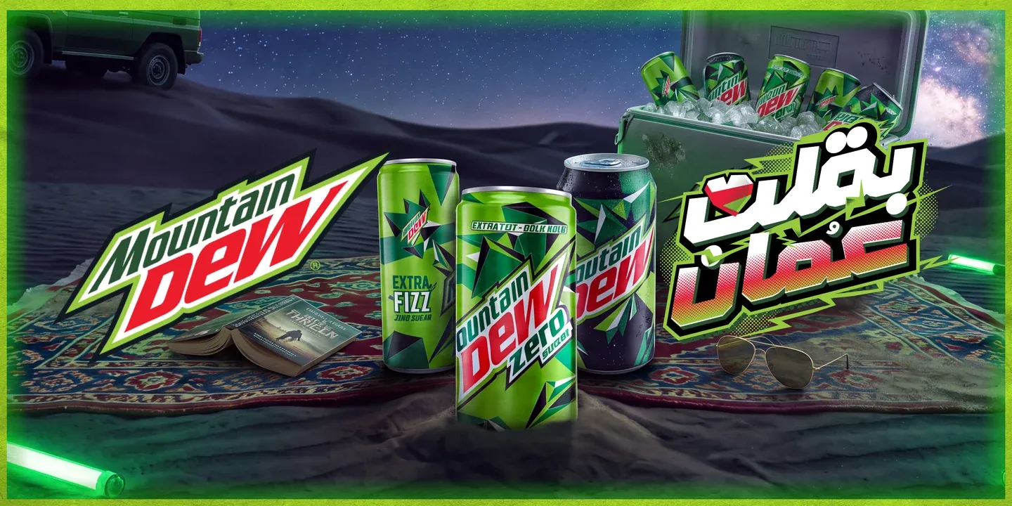 Mountain Dew cans and bottles arranged on a patterned rug in a desert night scene