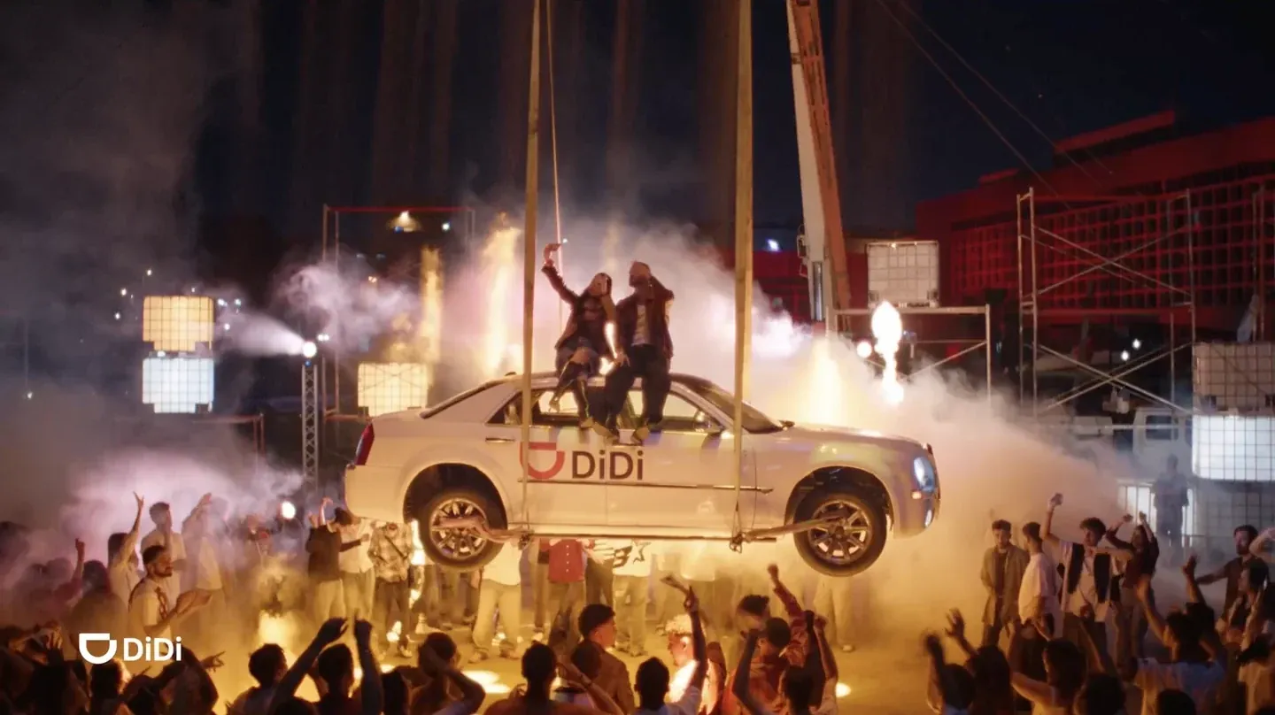 DiDi supplied real storyboard frame of a car and performers suspended above a crowd amid smoke and lights