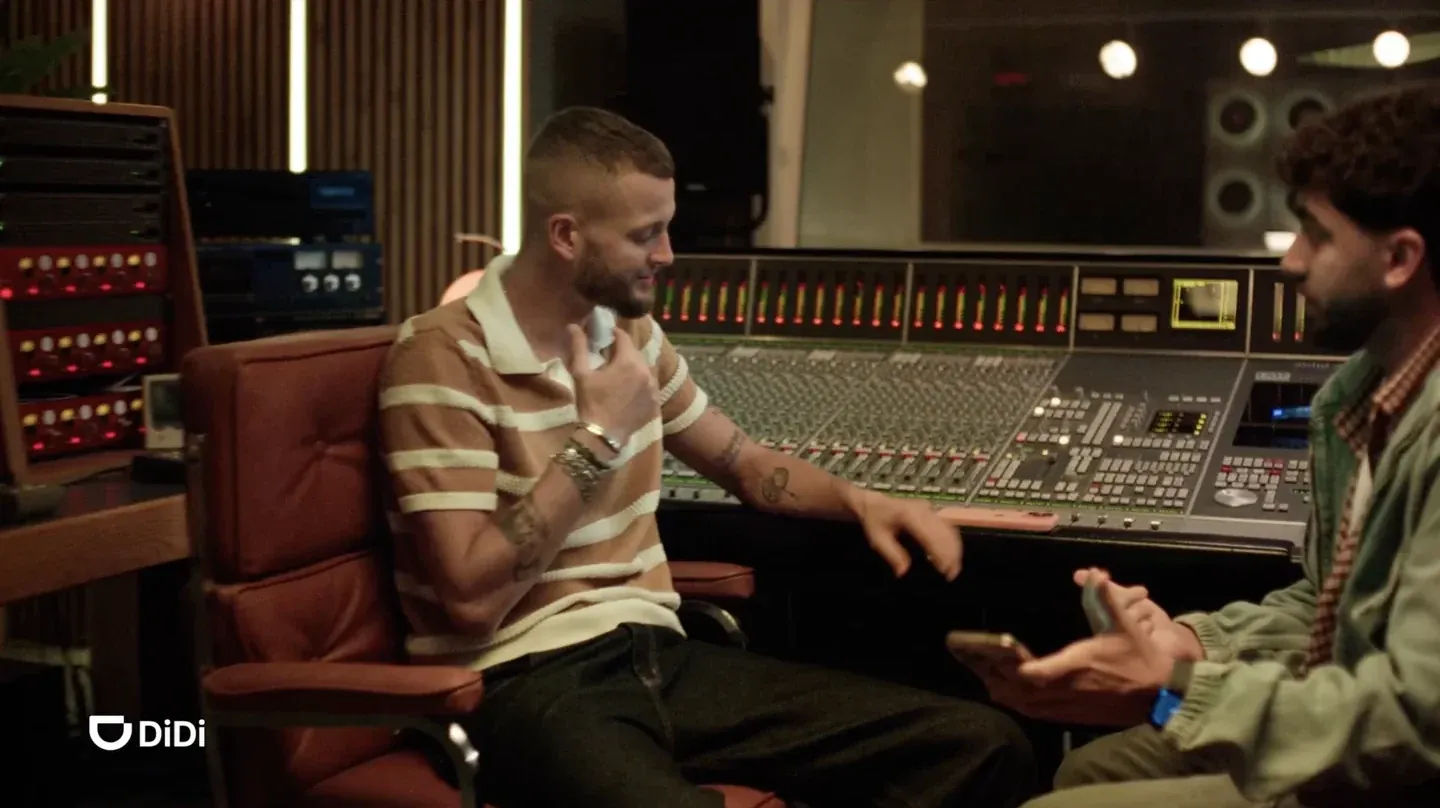 DiDi supplied real storyboard frame of two men beside an audio mixing desk in a recording studio